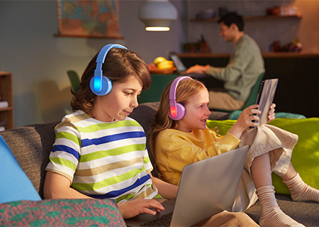 Kids using their Philips on-ear headphones colorful light-up panel feature