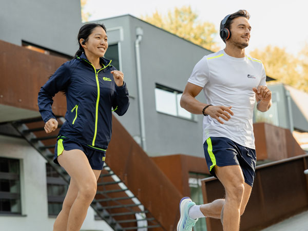 Two participants in the run are running with their Philips headphones.