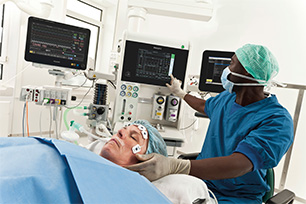 Anaesthesiologist using ICCA clinical information system during surgery.